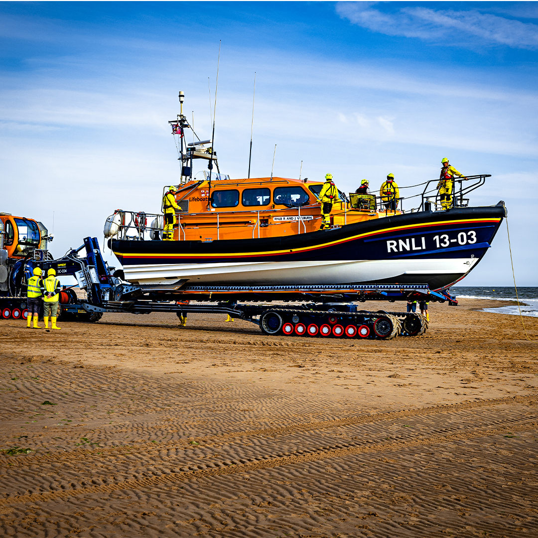 Exmouth's Shannon Class lifeboat on the sand with crew members