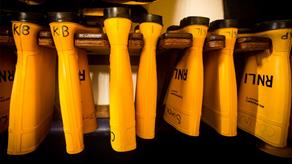 Yellow RNLI crew wellies hanging up in a station kit room