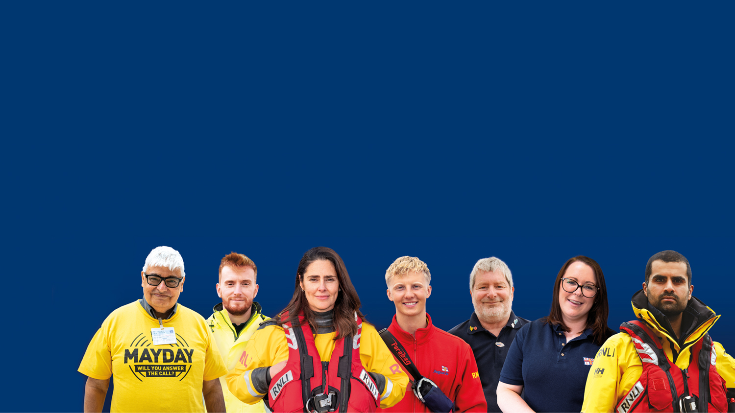 RNLI Staff and volunteers smiling at the camera with a blue background