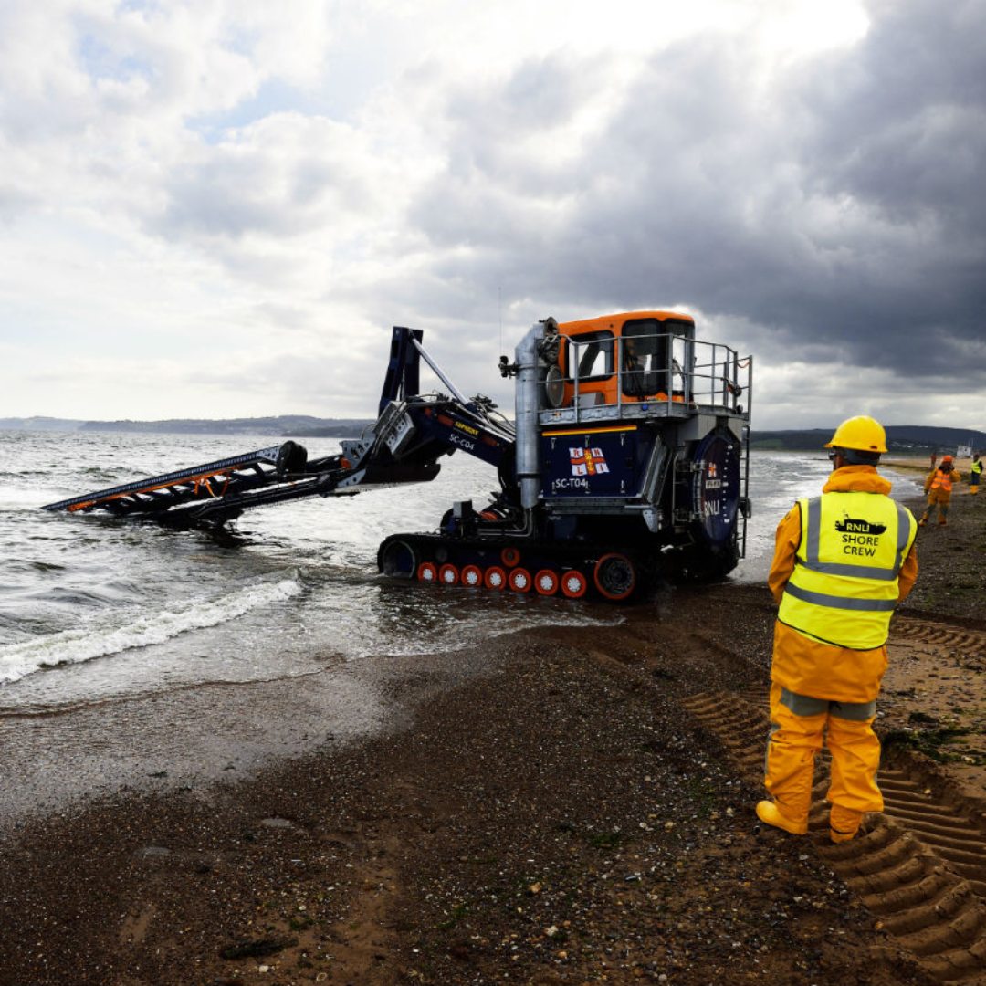 Shore crew volunteers helping launch a lifeboat via a tractor
