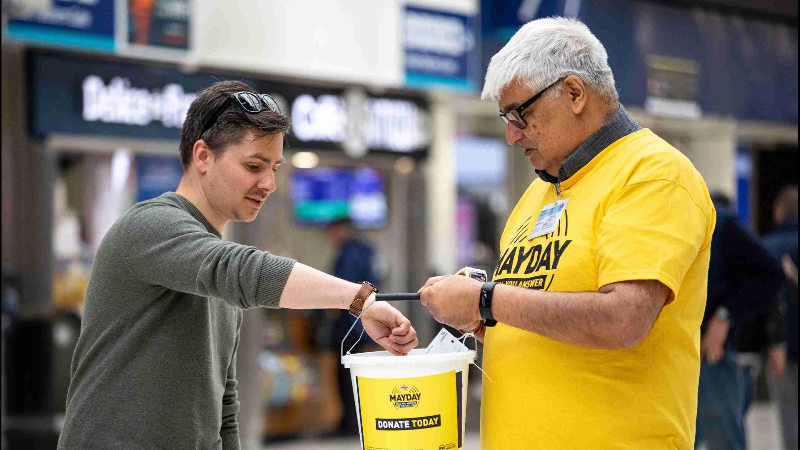 RNLI fundraising volunteer Suresh Bharwaney collecting at Waterloo train station.