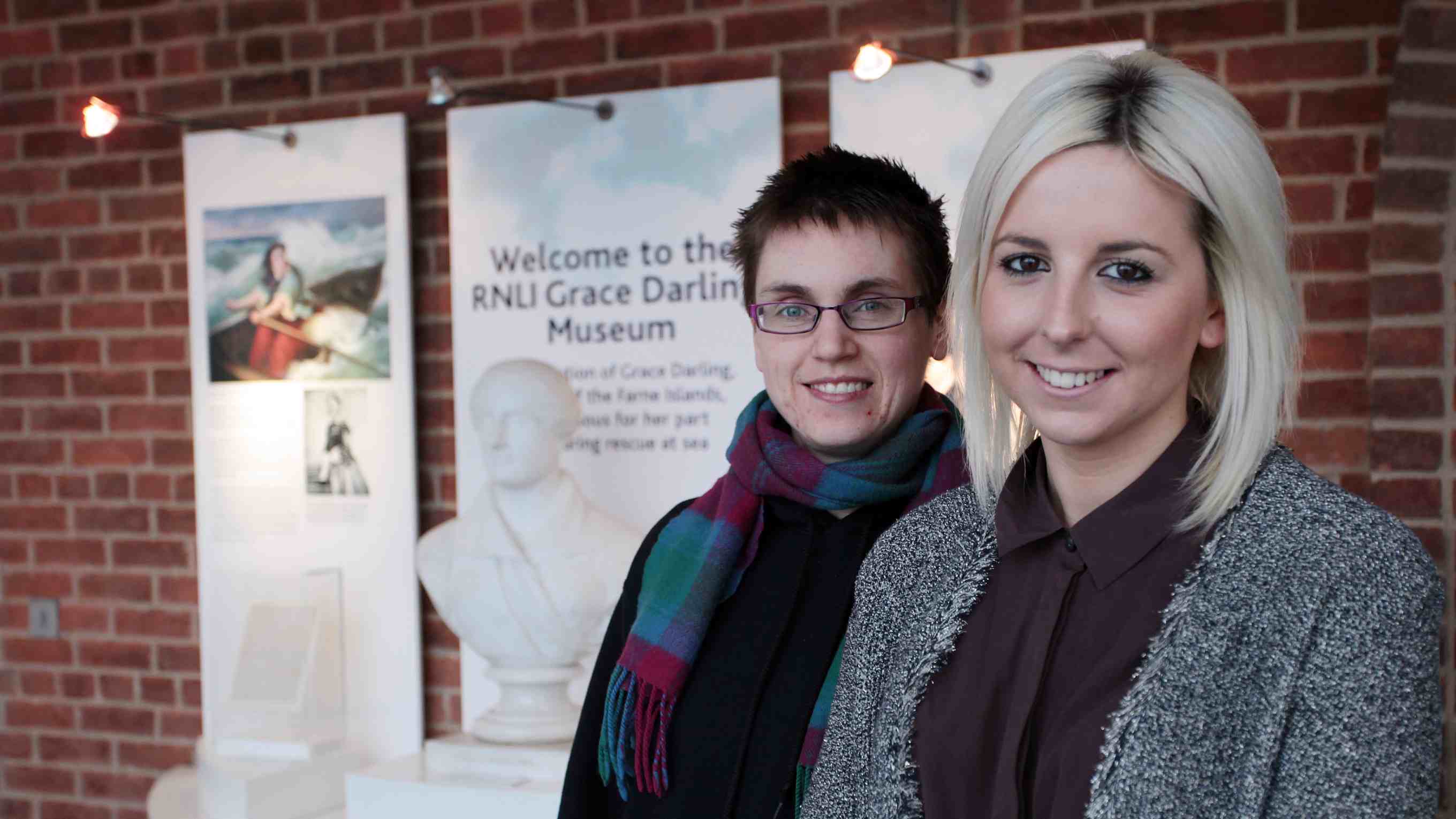 Volunteers Lucy Astbury and Lindsay Wilson at the Grace Darling museum in Bamburgh standing in front of museum artifacts