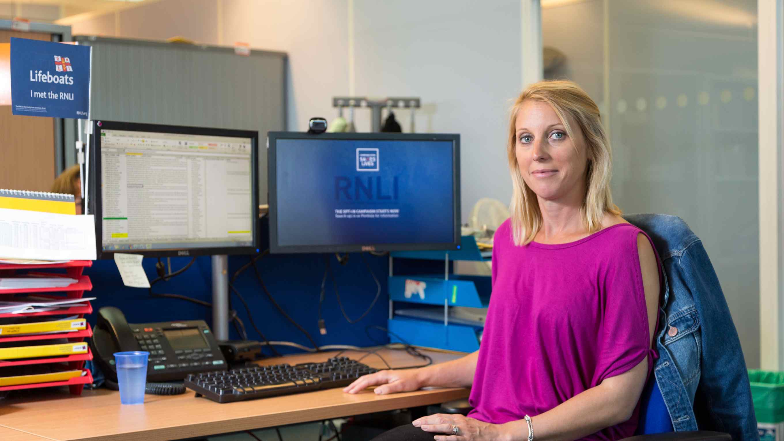 Office support volunteer Samantha Salmond sat at a desk in front of a computer, helping out in the RNLI’s People department