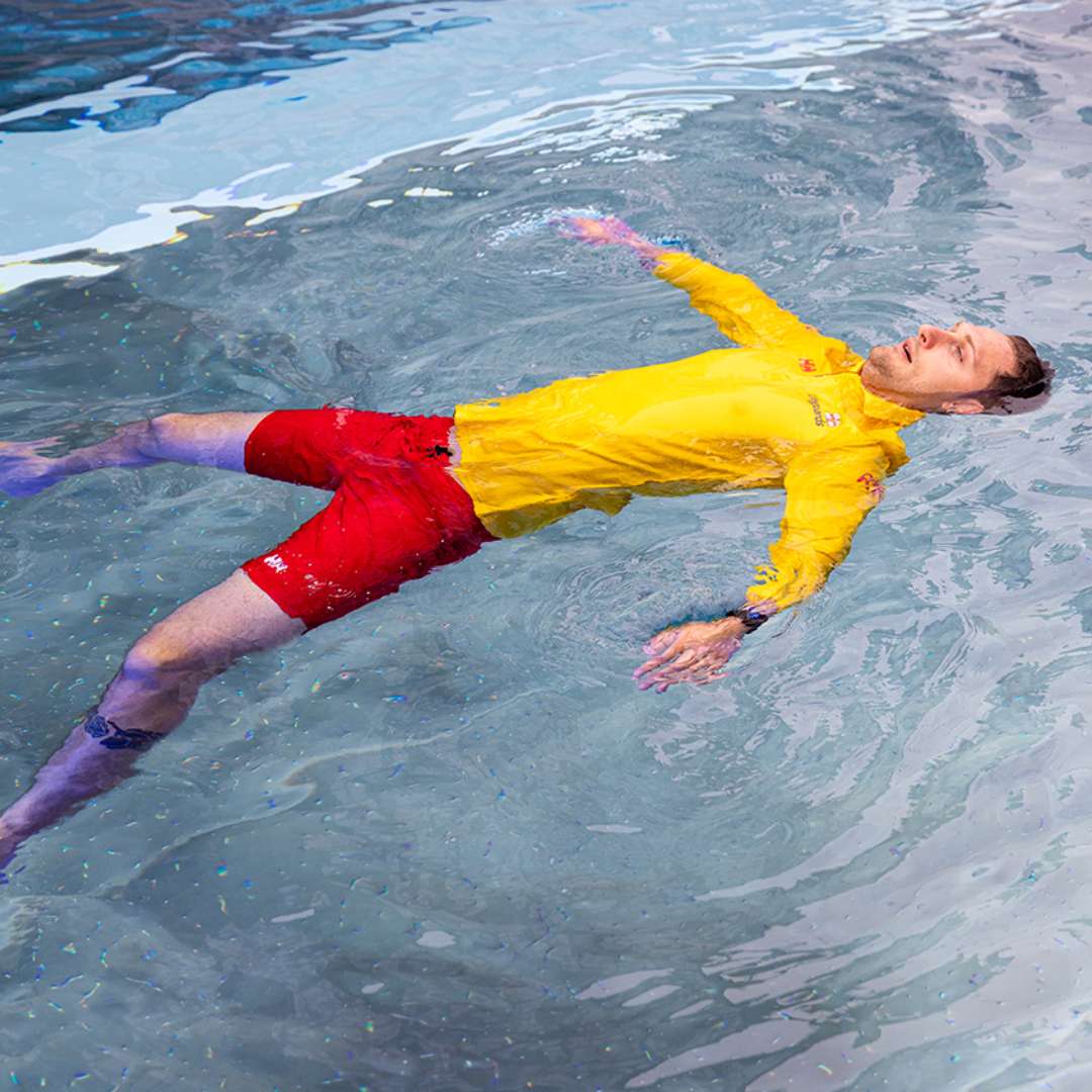 rnli volunteer floating in a swimming pool