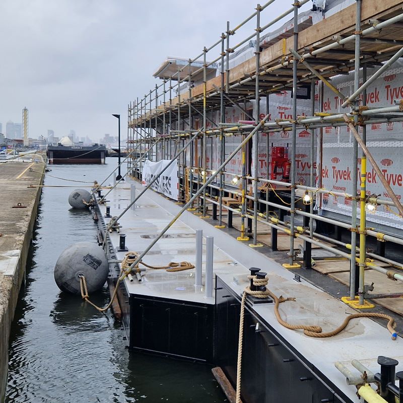 Scaffolding surrounds the exterior of Tower Lifeboat Station as it floats on the River Thames