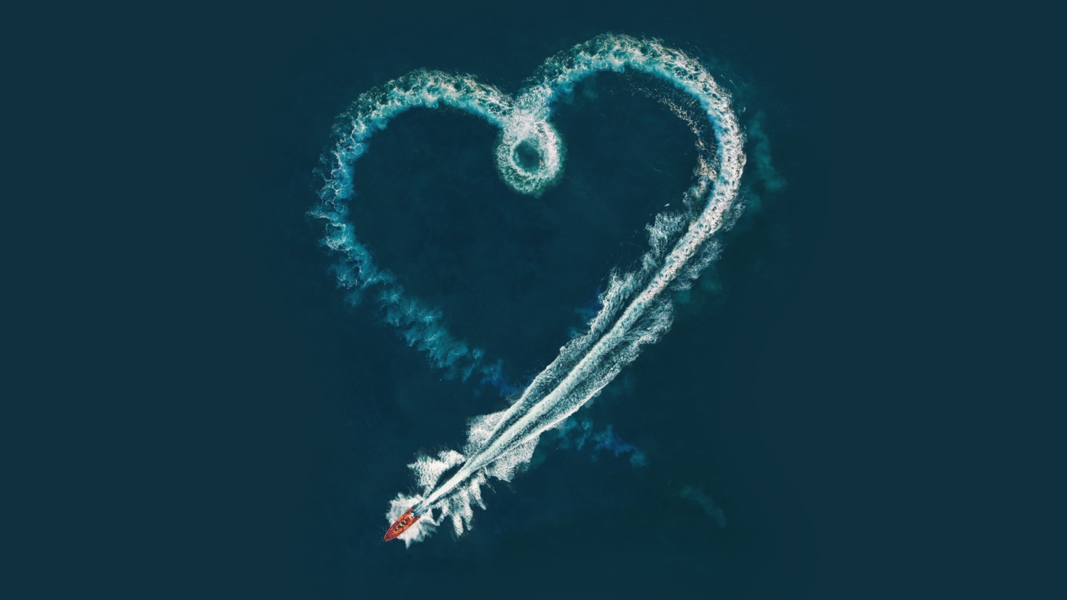 An aerial view of the wake of a lifeboat in the shape of a heart.